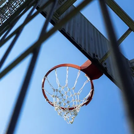 A basketball hoop against a blue sky