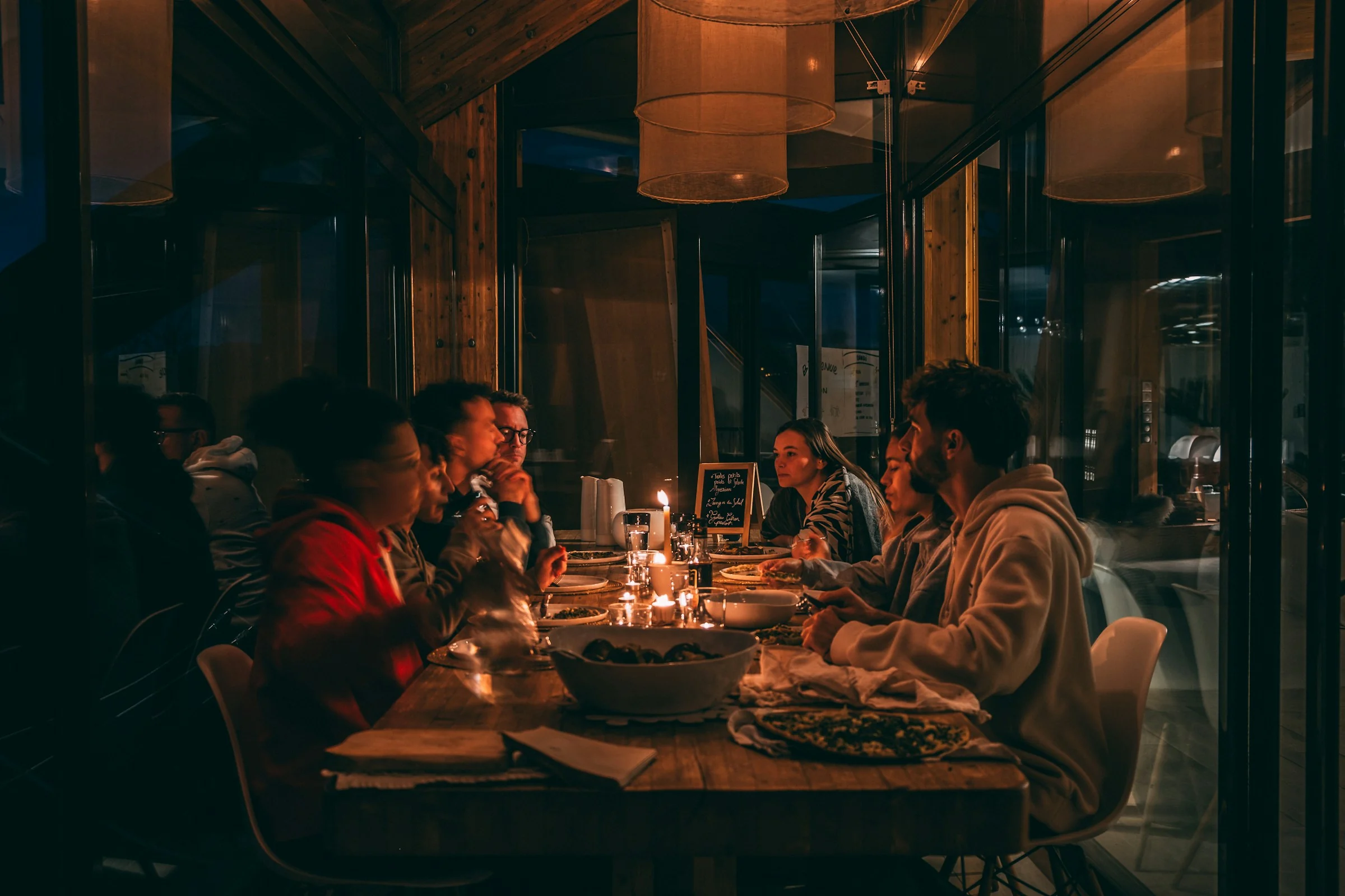 Friends sharing a candlelit dinner
