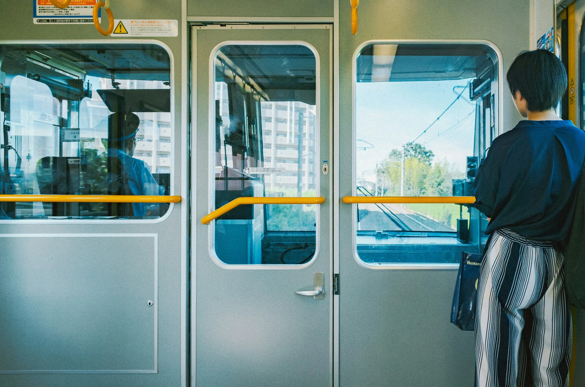 A passenger looking through the front window of a city train
